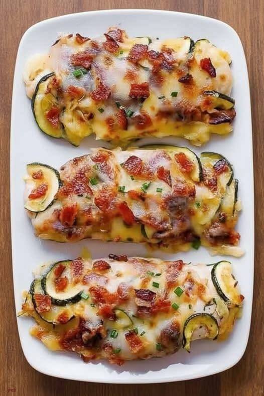 Baked Chicken Zucchini with Bacon is a low carb dinner packed with protein and veggies! Chicken breasts are smothered with Mozzarella and Parmesan cheeses. Everything is baked in a casserole dish. This easy and quick.